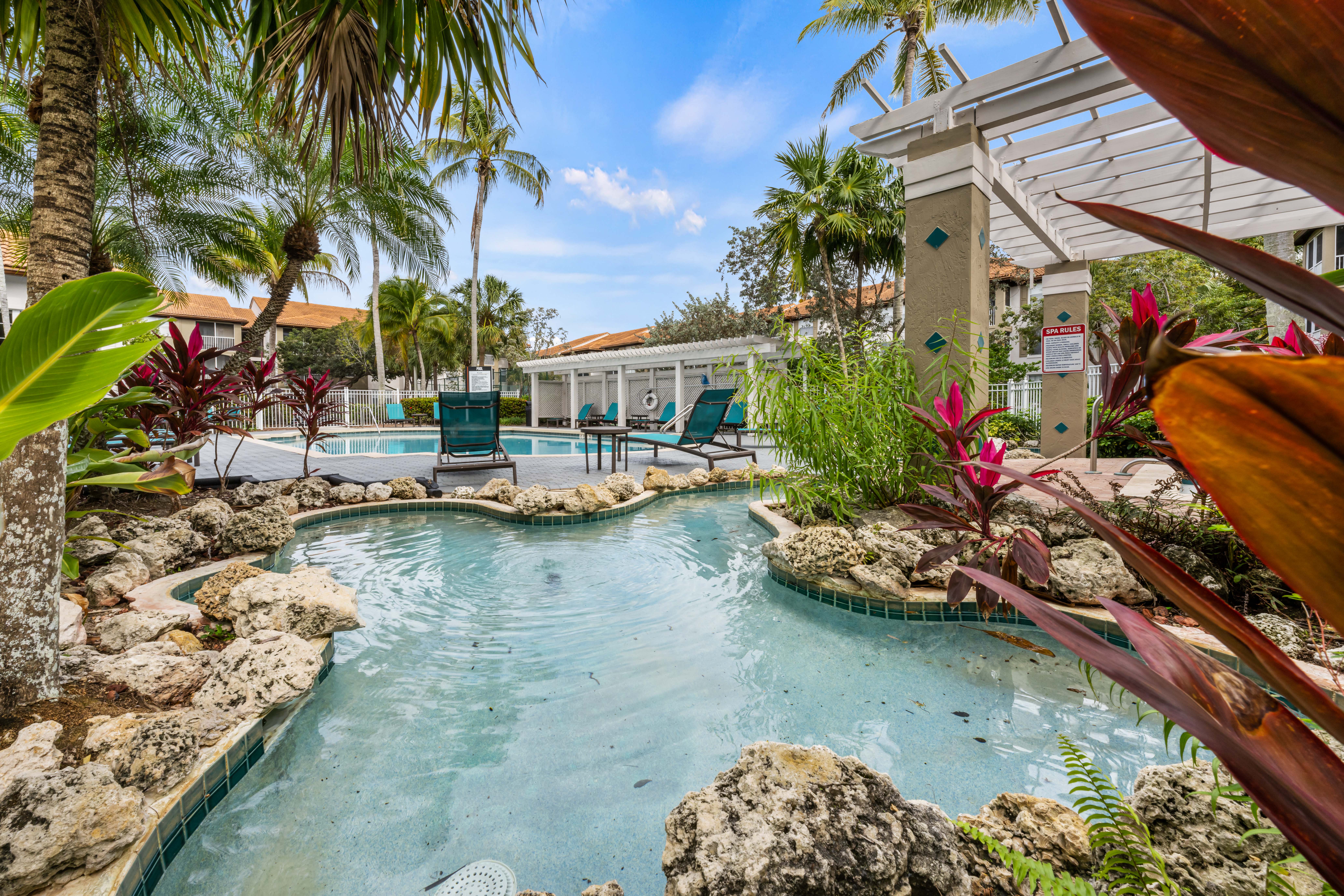 A pool surrounded by rocks and plants.